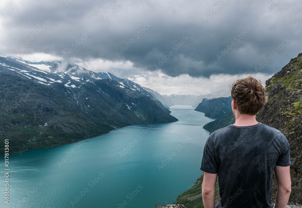 Fototapeta premium hiker looking out over Gjende lake on the besseggen ridge Norway