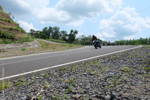 Man riding a classic motorcycle on highway of mountain