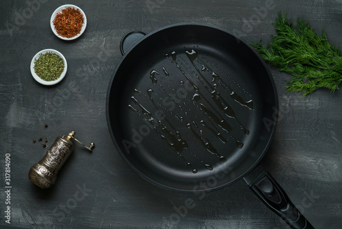 oil on the frying pan - Top View on a dark background