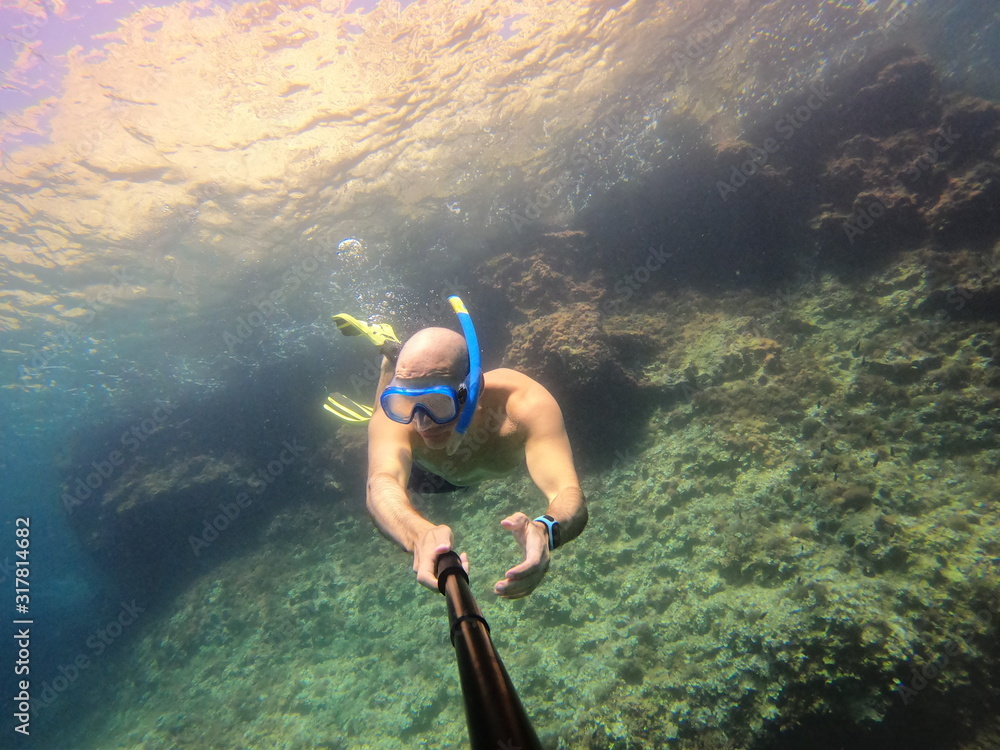 underwater man snorkeling in the sea withcrystal-clear waters concept of holiday relax summer beach diver in the sea underwater man snorkeling in the sea withcrystal-clear waters concept of holiday relax summer beach diver in the sea