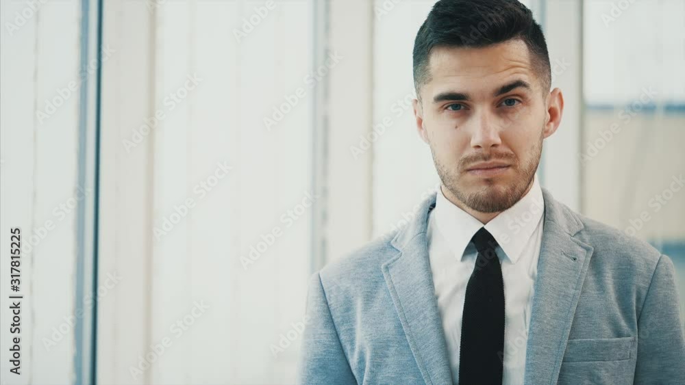 Business man is serious, looking at the camera, isolated on white blurred background. Close up. Copy space. 4K. Business man is serious, looking at the camera, isolated on white blurred background. Close up. Copy space. 4K.
