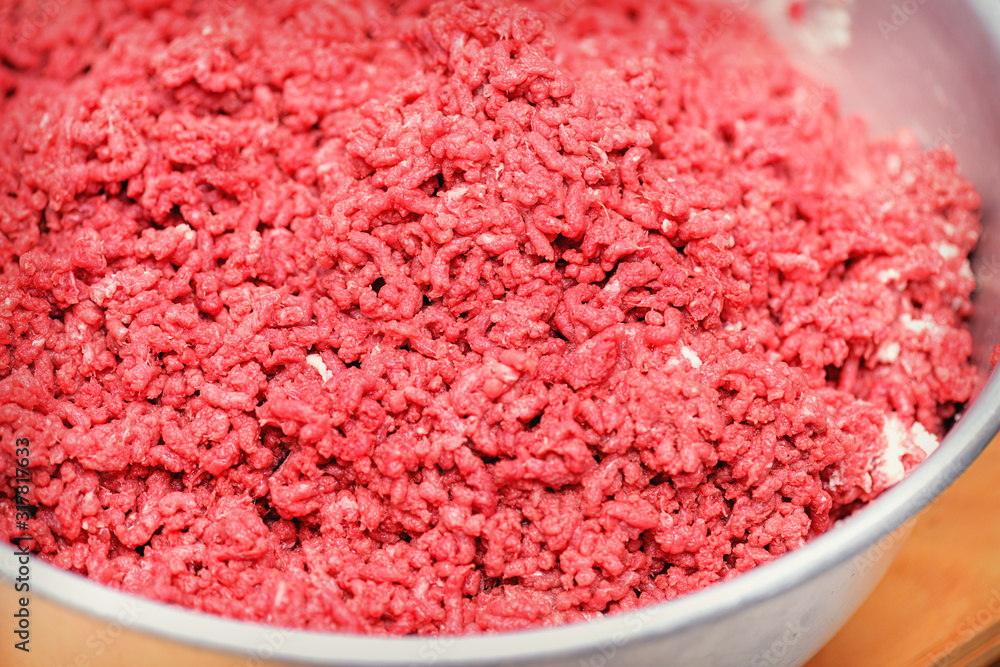 Minced meat. Advertising of fresh minced meat in minced meat close up. Chopped meat through manual meat grinder close-up. Copy space on the background of minced meat. Minced meat. Advertising of fresh minced meat in minced meat close up. Chopped meat through manual meat grinder close-up. Copy space on the background of minced meat.