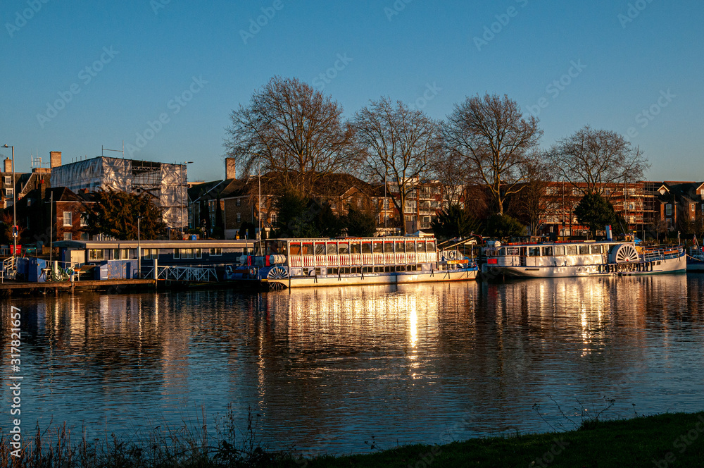 Boats and barges on the River Thames at Kingston-Upon-Thames at dusk