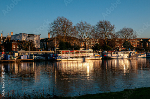 Boats and barges on the River Thames at Kingston-Upon-Thames at dusk