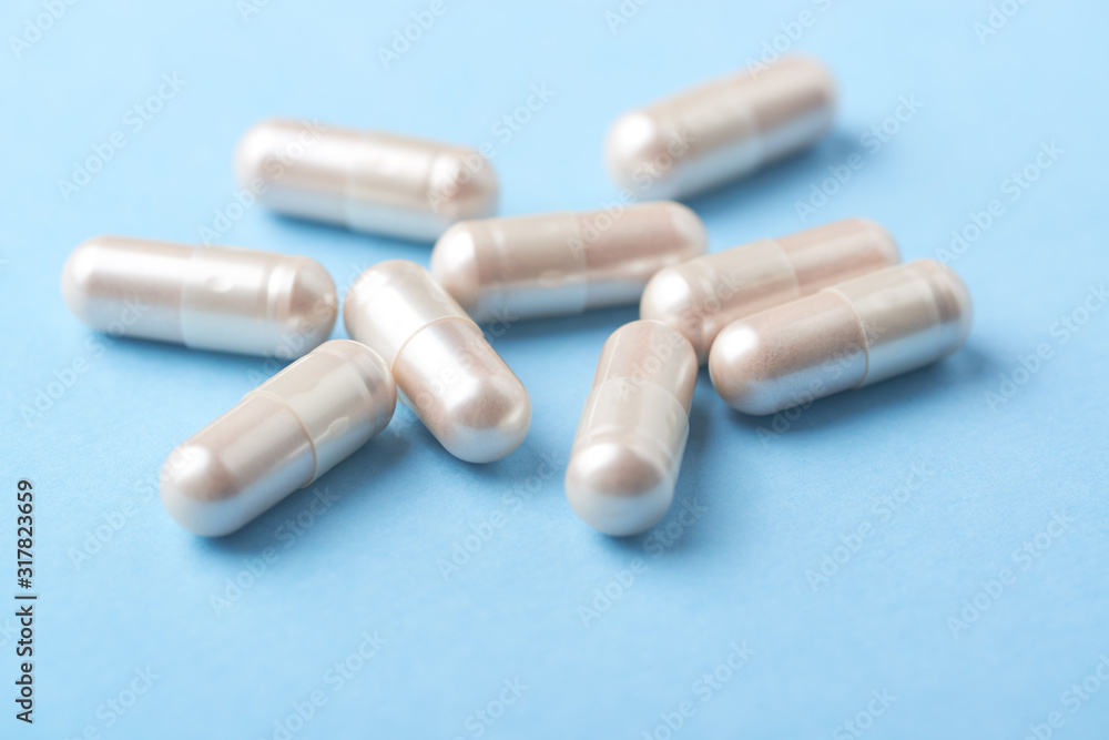 Carnitine capsules. Concept for a healthy dietary supplementation. Bright paper background. Soft focus. Close up. Carnitine capsules. Concept for a healthy dietary supplementation. Bright paper background. Soft focus. Close up.