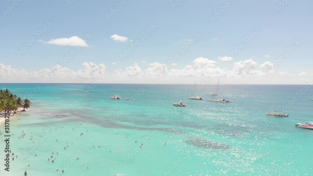 Drone shot of boats on the water close to the paradise shore Drone shot of boats on the water close to the paradise shore