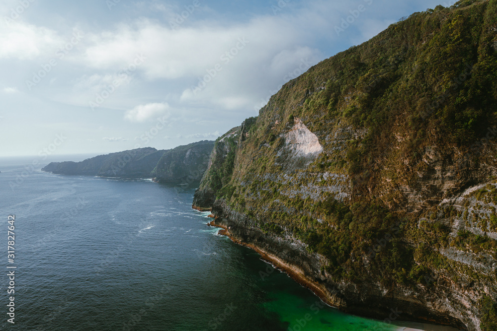 Manta Bay or Kelingking Beach on Nusa Penida Island, Bali, Indonesia. The most beautiful and popular beach with azure water and white sandy beach under new angle of view from drone