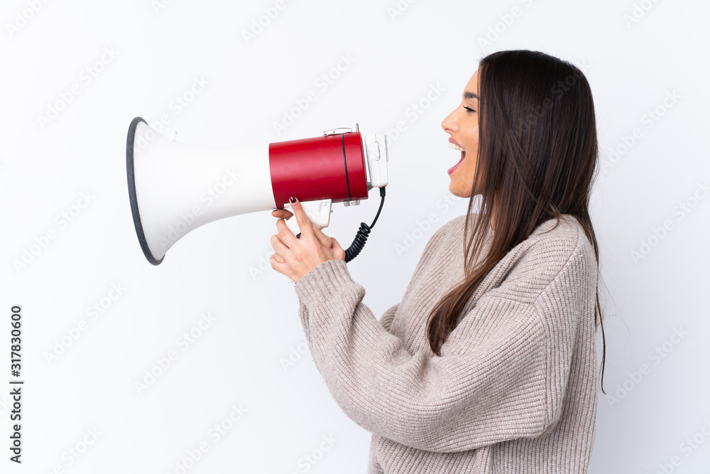 Young brunette woman over isolated white background shouting through a megaphone Young brunette woman over isolated white background shouting through a megaphone