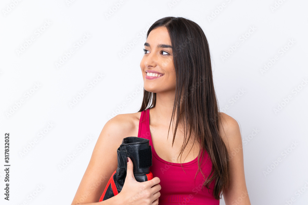 Young sport brunette woman over isolated white background with boxing gloves Young sport brunette woman over isolated white background with boxing gloves