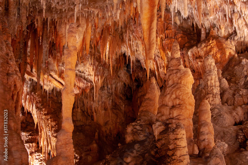A cave with all types of formations. Orange light. Yarrangobilly Caves, Kosciuszko National Park, NSW, Australia.