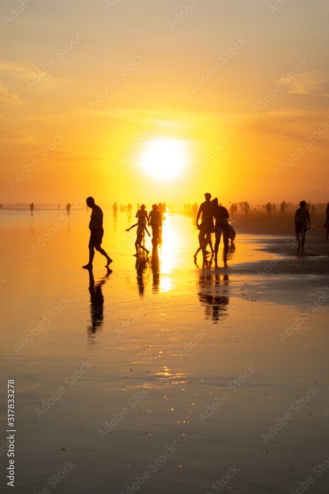 sunset at sea with reflected people
