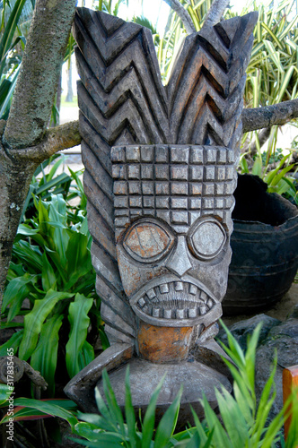 A traditional Hawaiian totem or wood carving with a fierce warrior to ward off evil spirits. 