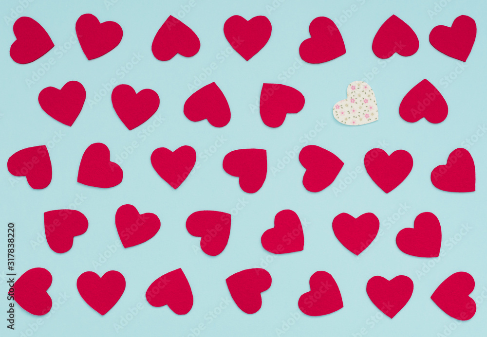 Valentine's Day blue background with lots of felt red hearts and one white with flowers heart. Greeting or invitation card. Wedding, love, happiness concept. Flat lay style, top view. Valentine's Day blue background with lots of felt red hearts and one white with flowers heart. Greeting or invitation card. Wedding, love, happiness concept. Flat lay style, top view.