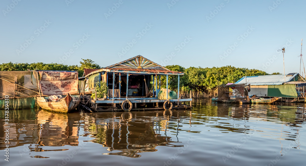 The Floating Village of Kampong Khleang on Tonle Sap Lake at Siem Reap Cambodia During Sunset The Floating Village of Kampong Khleang on Tonle Sap Lake at Siem Reap Cambodia During Sunset