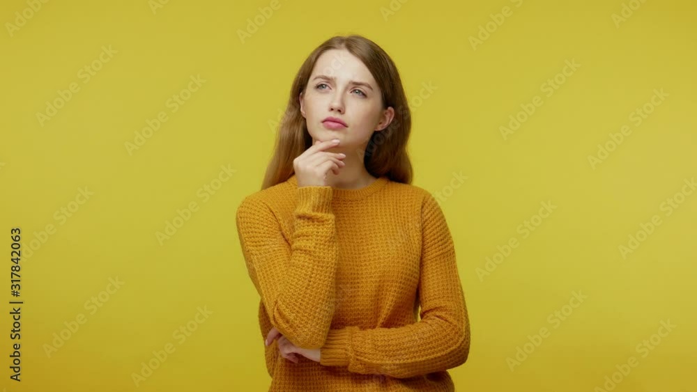 Smart thoughtful beautiful girl with brown hair in pullover pondering and being inspired by sudden solution, surprised by genius idea in mind, got answer. studio shot isolated on yellow background Smart thoughtful beautiful girl with brown hair in pullover pondering and being inspired by sudden solution, surprised by genius idea in mind, got answer. studio shot isolated on yellow background