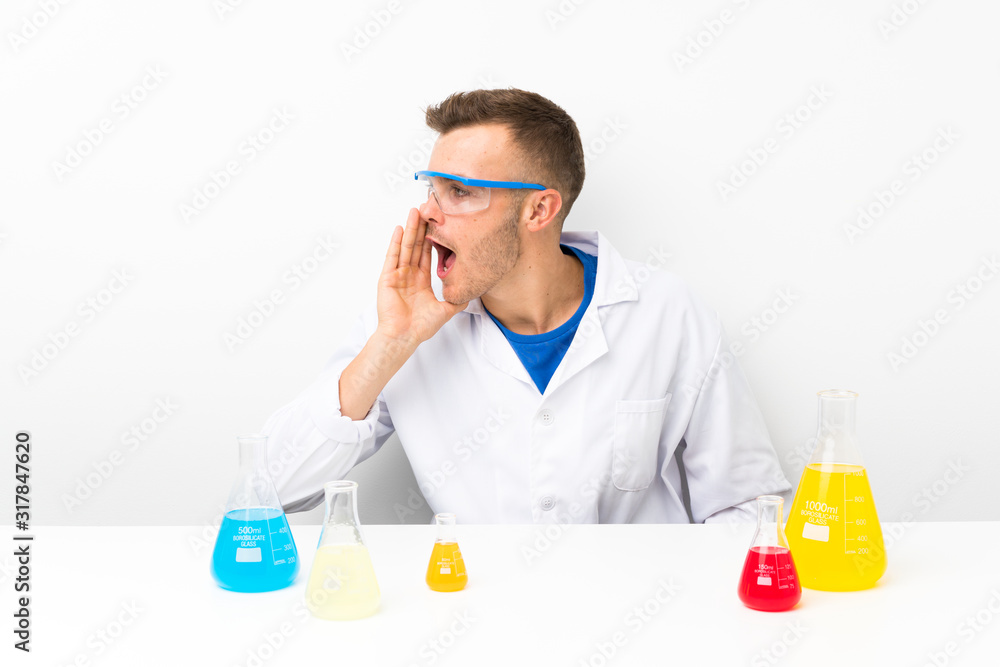 Young scientific with lots of laboratory flask shouting with mouth wide open Young scientific with lots of laboratory flask shouting with mouth wide open