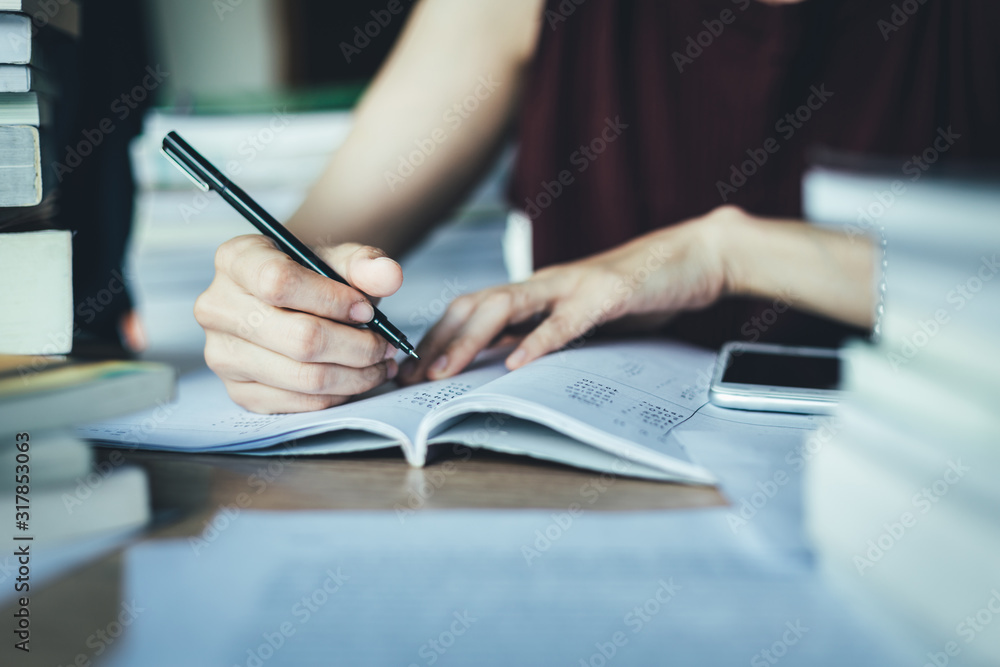 high school,university student study.hands holding pencil writing paper answer sheet.sitting lecture chair taking final exam attending in examination classroom.concept scholarship for education abroad high school,university student study.hands holding pencil writing paper answer sheet.sitting lecture chair taking final exam attending in examination classroom.concept scholarship for education abroad
