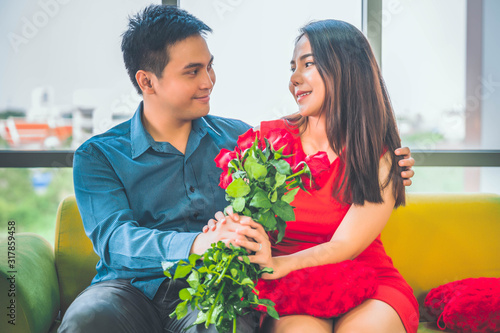 Beautiful young couple in Living room. Celebrating Saint Valentine's Day.