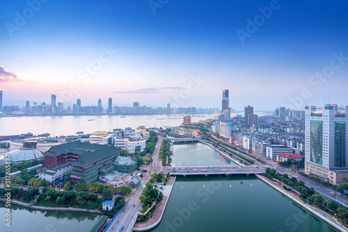 Bird view at Nanchang China. Skyscraper under construction in foreground. Fog  overcast sky and pollution. Bund  Nanchang  area