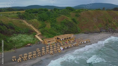 Drone flying forward to closed bar on the beach photo