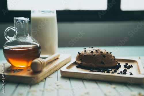 healthy eating and traditional bakery concept; fresh bread on the kitchen table with beverage at morning