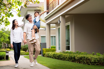 Beautiful family portrait smiling outside their new house
