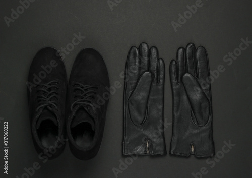 Women's fashion accessories on a black background. Suede boots, leather gloves. Top view
