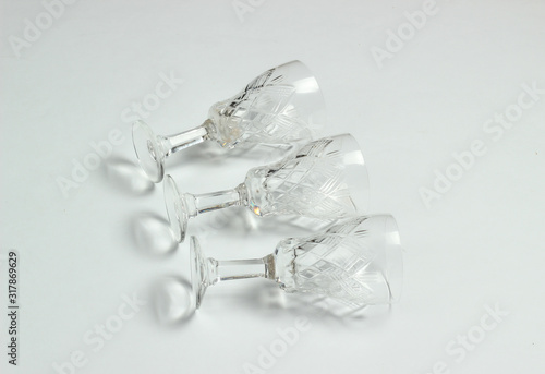 Retro style faceted crystal wine glasses on a white background.