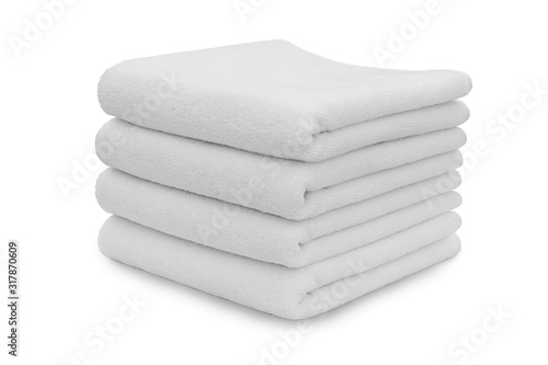 Stack of white plush hotel towels isolated on white background