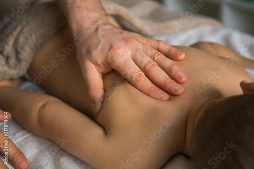 фотографія Boy toddler relaxes from a therapeutic massage
