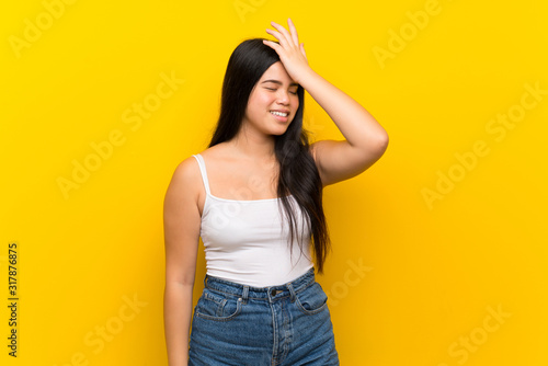 Young teenager Asian girl over isolated yellow background has realized something and intending the solution