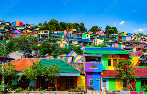 Semarang, Indonesia - 27th May 2017: Colorful houses in Kalisari Rainbow Village (Kampung Pelangi Kalisari) in Semarang, Indonesia. The writing translates to Rainbow Village Wonosari City photo