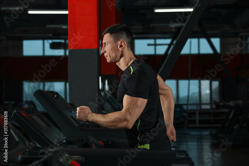 Man working out on treadmill in modern gym