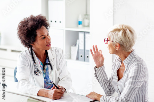 Mature woman talk with her doctor about health in clinic