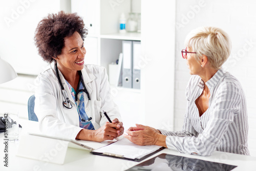 Mature woman talk with her doctor about health in clinic