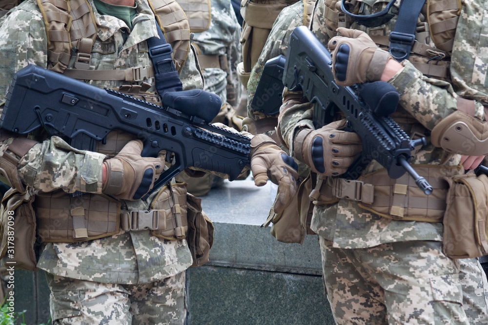 Automatic rifles in the hands of soldiers close up. Weaponry Automatic rifles in the hands of soldiers close up. Weaponry