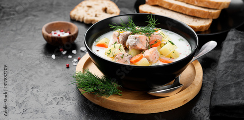 Creamy soup with salmon, potatoes, carrots and dill. Healthy food.