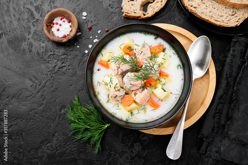 Creamy soup with  salmon, potatoes, carrots and dill. Healthy food. photo