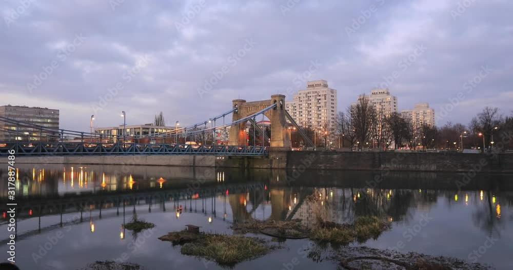 Grunwald Bridge (Most Grunwaldzki) reflecting in Oder river at dusk in Wroclaw, Poland Grunwald Bridge (Most Grunwaldzki) reflecting in Oder river at dusk in Wroclaw, Poland