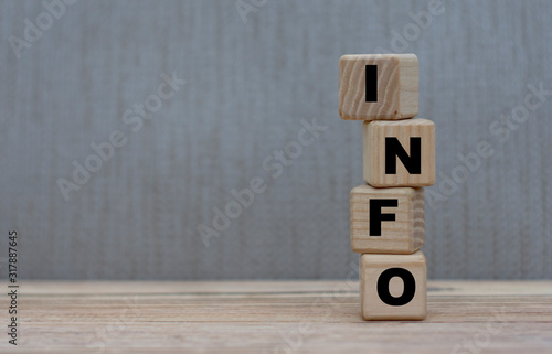 concept word information on wooden cubes on a gray background