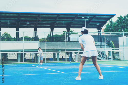 Sport concept; Young people playing tennis on court and relaxing of sport