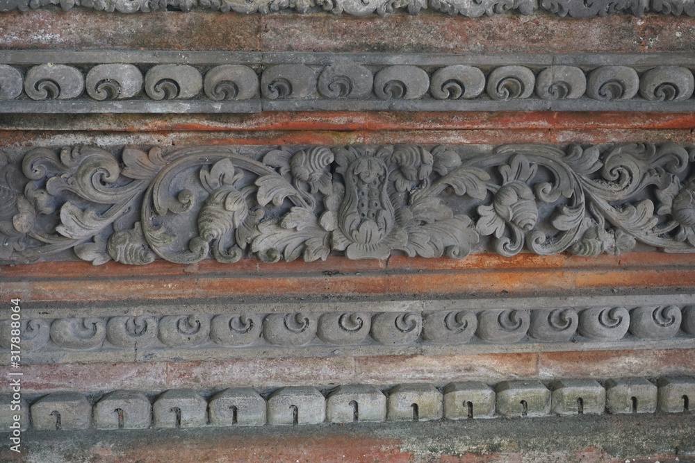 Decorative carved stone ornaments on a temple wall in Bali Indonesia