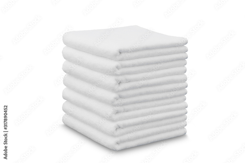 Stack of white plush hotel towels isolated on white background Stack of white plush hotel towels isolated on white background