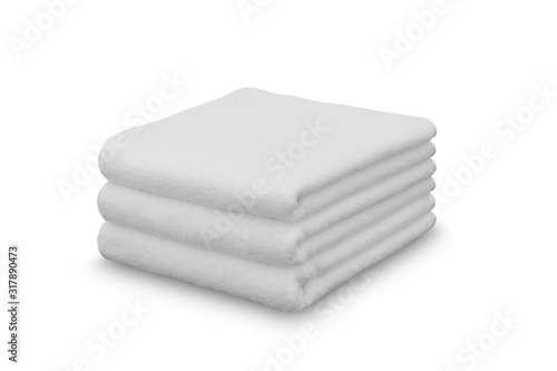 Stack of white plush hotel towels isolated on white background