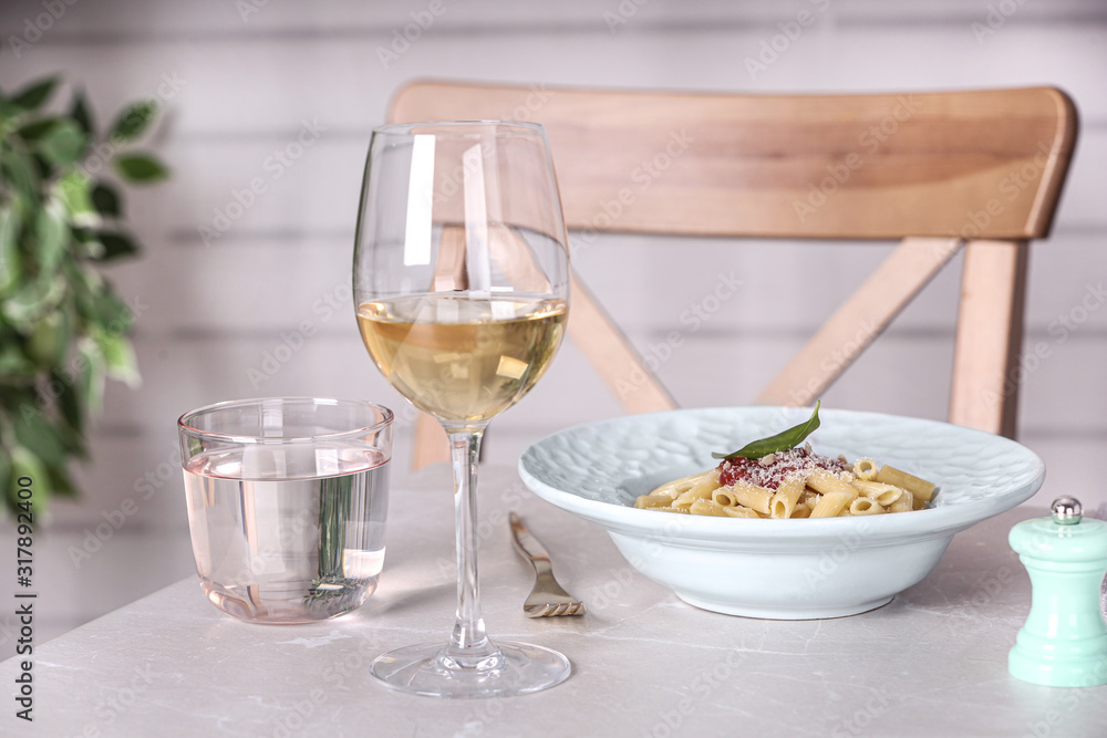 Delicious pasta with tomato sauce served on light marble table Delicious pasta with tomato sauce served on light marble table