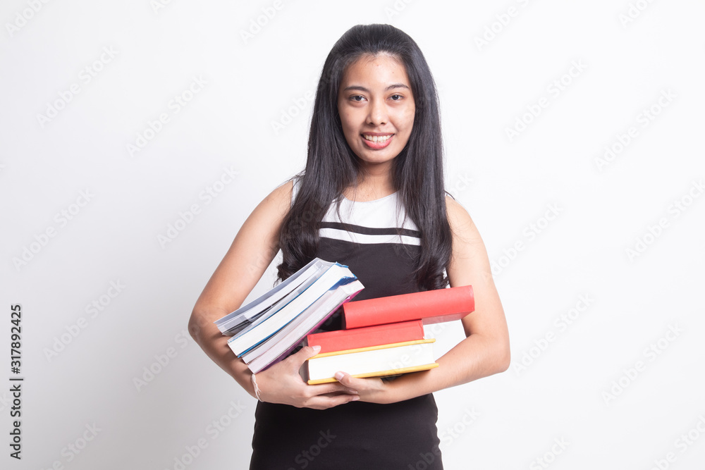 Young Asian woman studying  with may books.