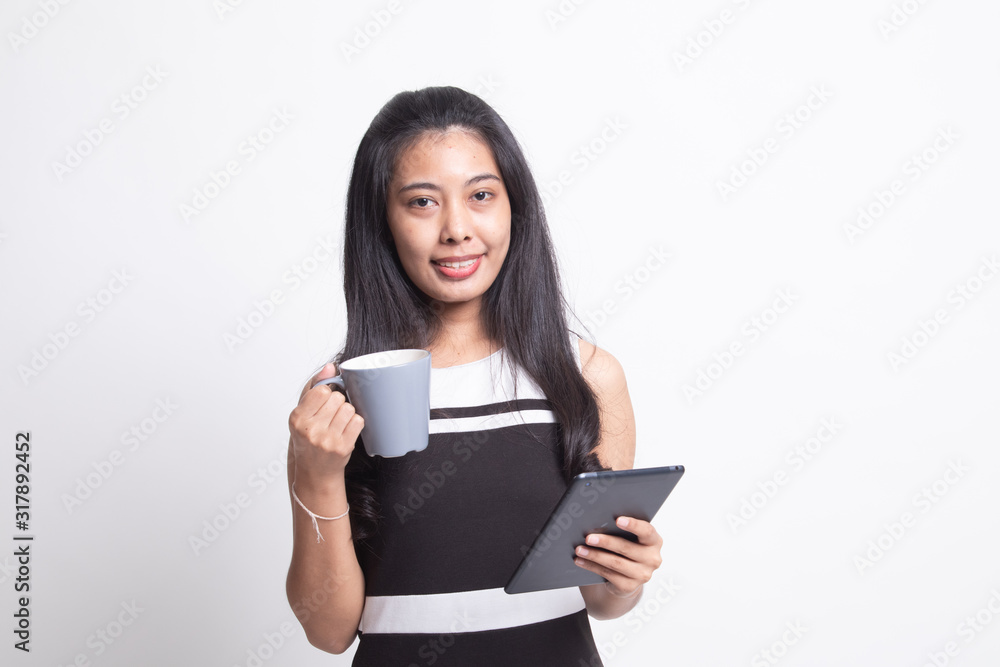 Young Asian woman with a computer tablet and coffee.