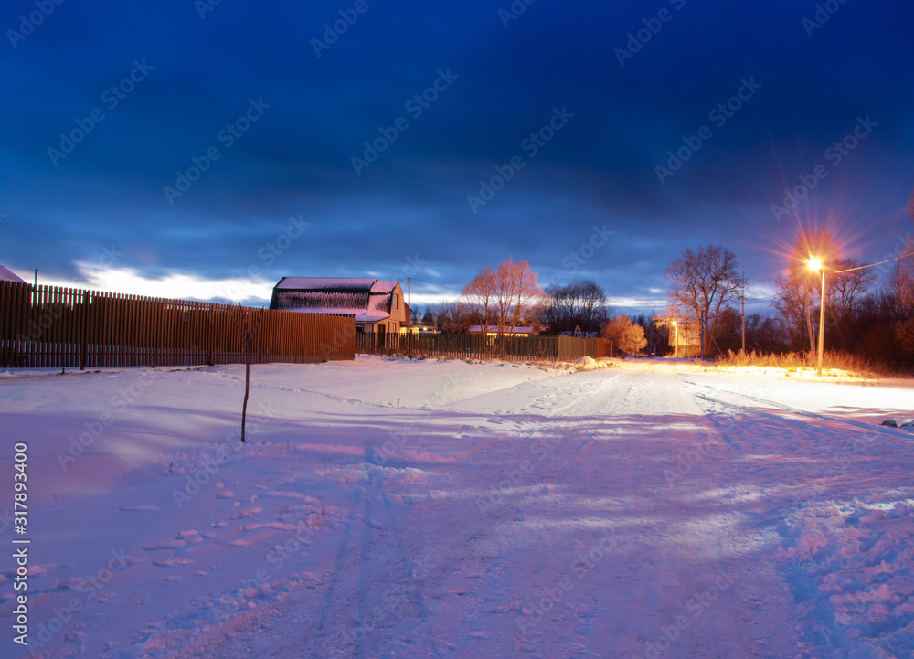 Deep night in a winter village. White snow, black skye, clouds
