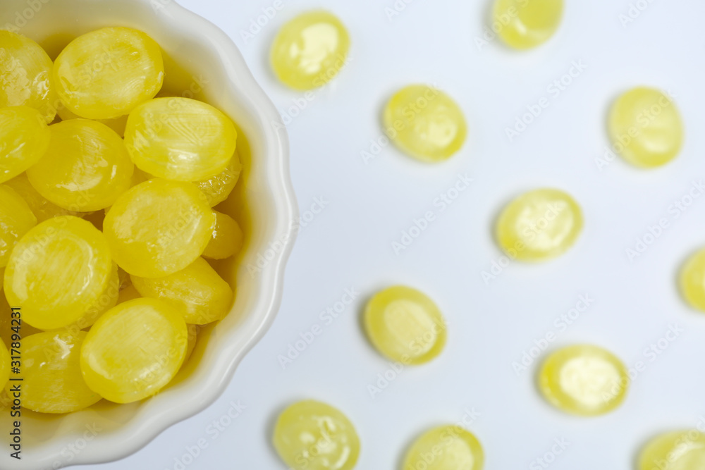Flat lay composition with tasty lemon drops on white background Flat lay composition with tasty lemon drops on white background