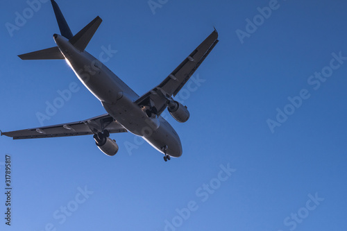 Close bottom view to landing passenger jet with clear sky at munich